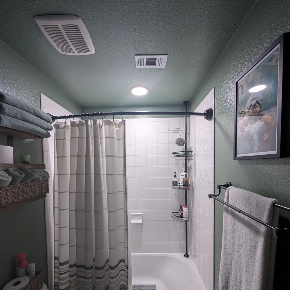 Bathroom with a round sensor light glowing on the ceiling